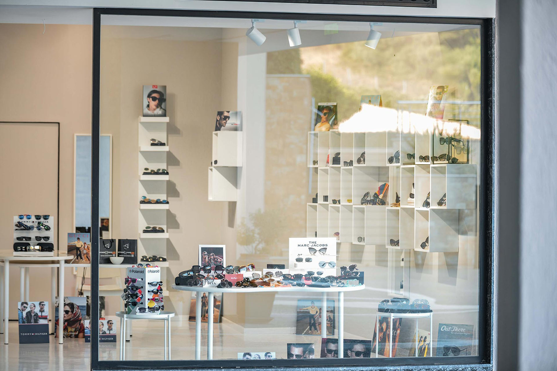 Optikon Xpress store window displaying designer sunglasses and eyewear