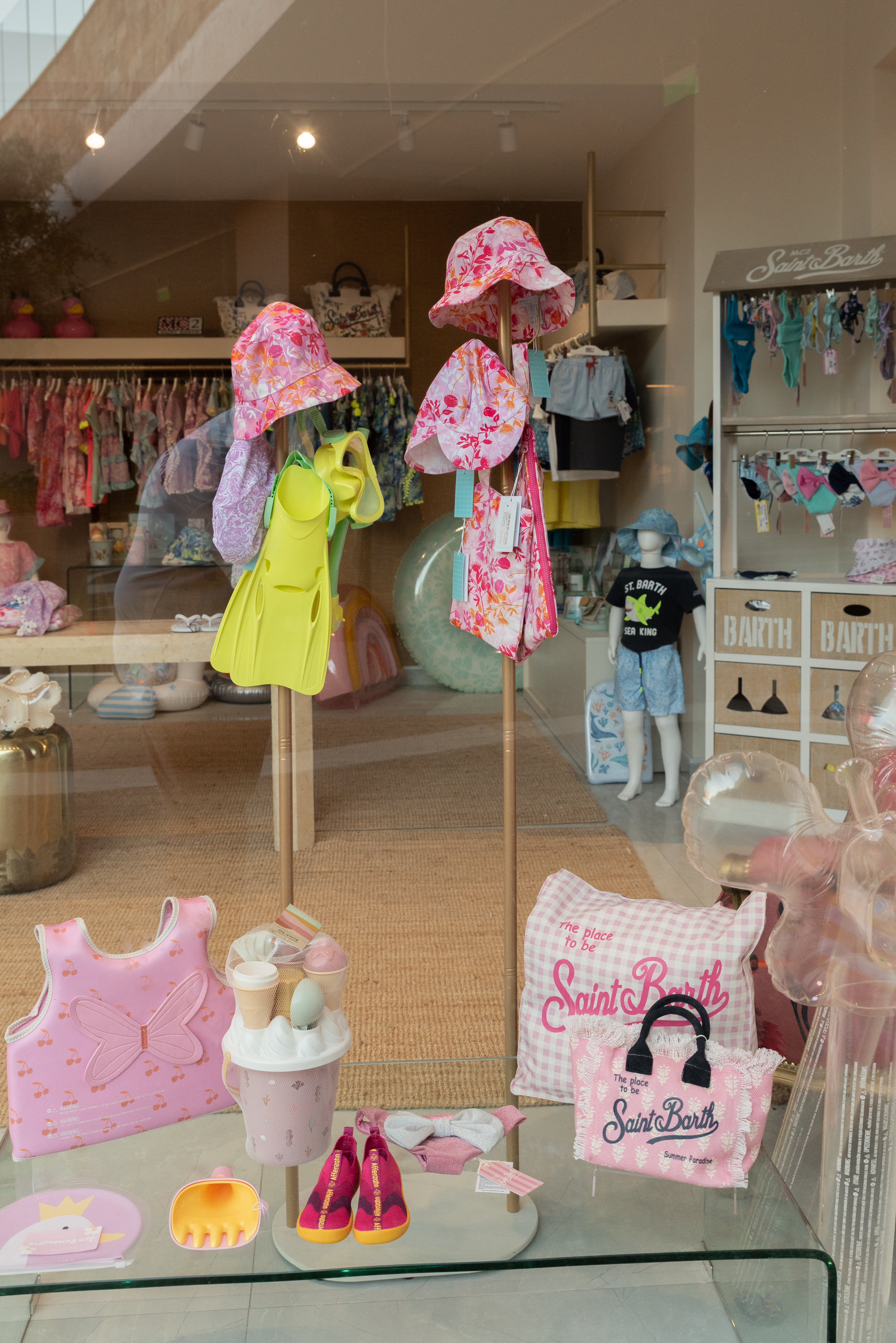 Children's clothing in pink and red tones with matching accessories and bags