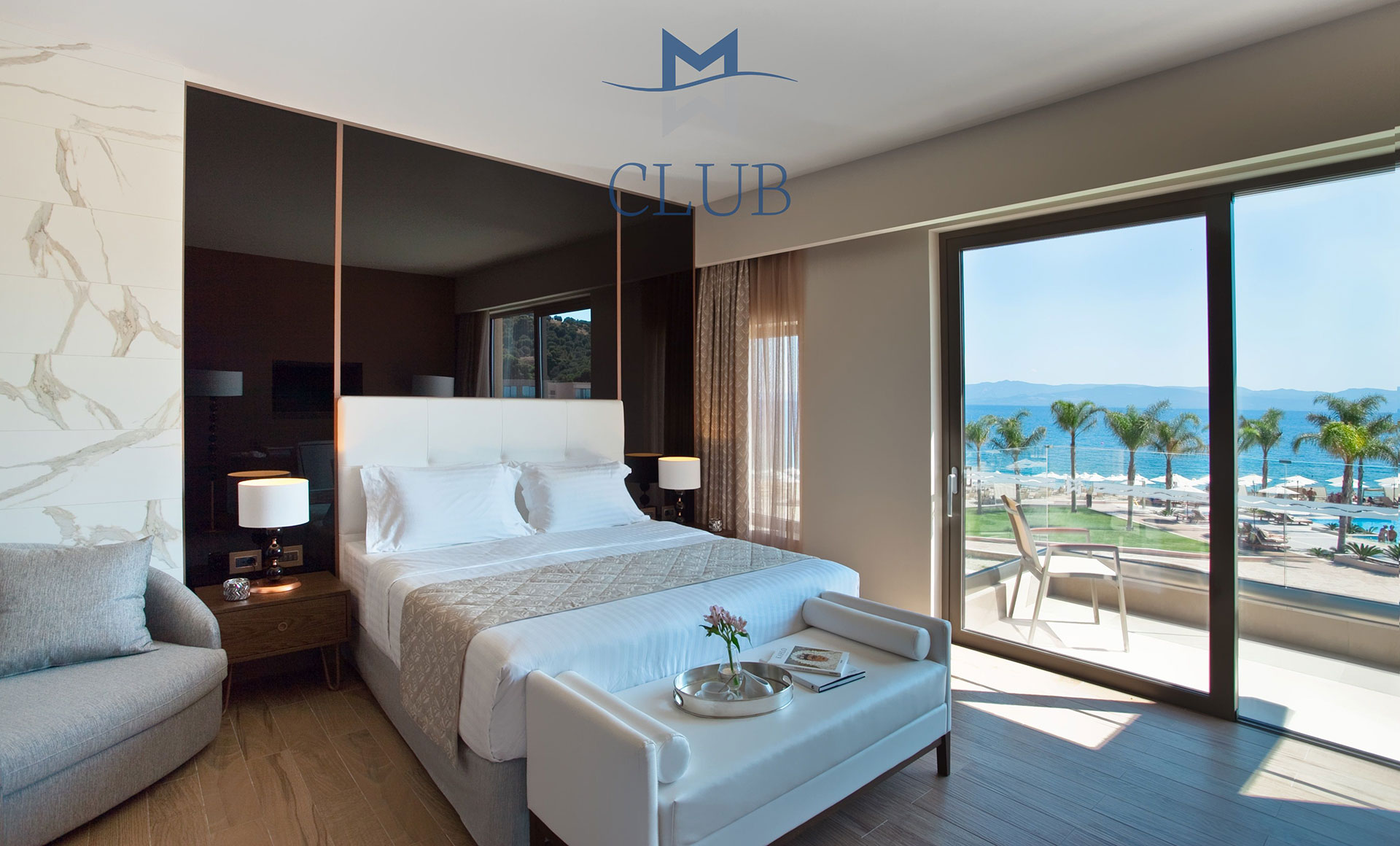 Duplex suite's bedroom with black modern accents, double bed and balcony with sea view
