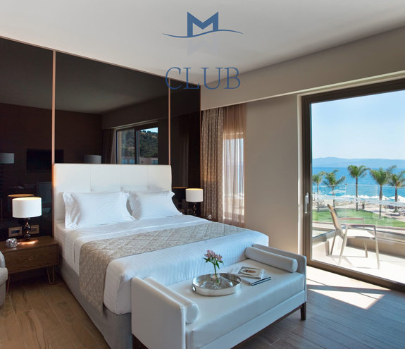 Duplex suite's bedroom with black modern accents, double bed and balcony with sea view