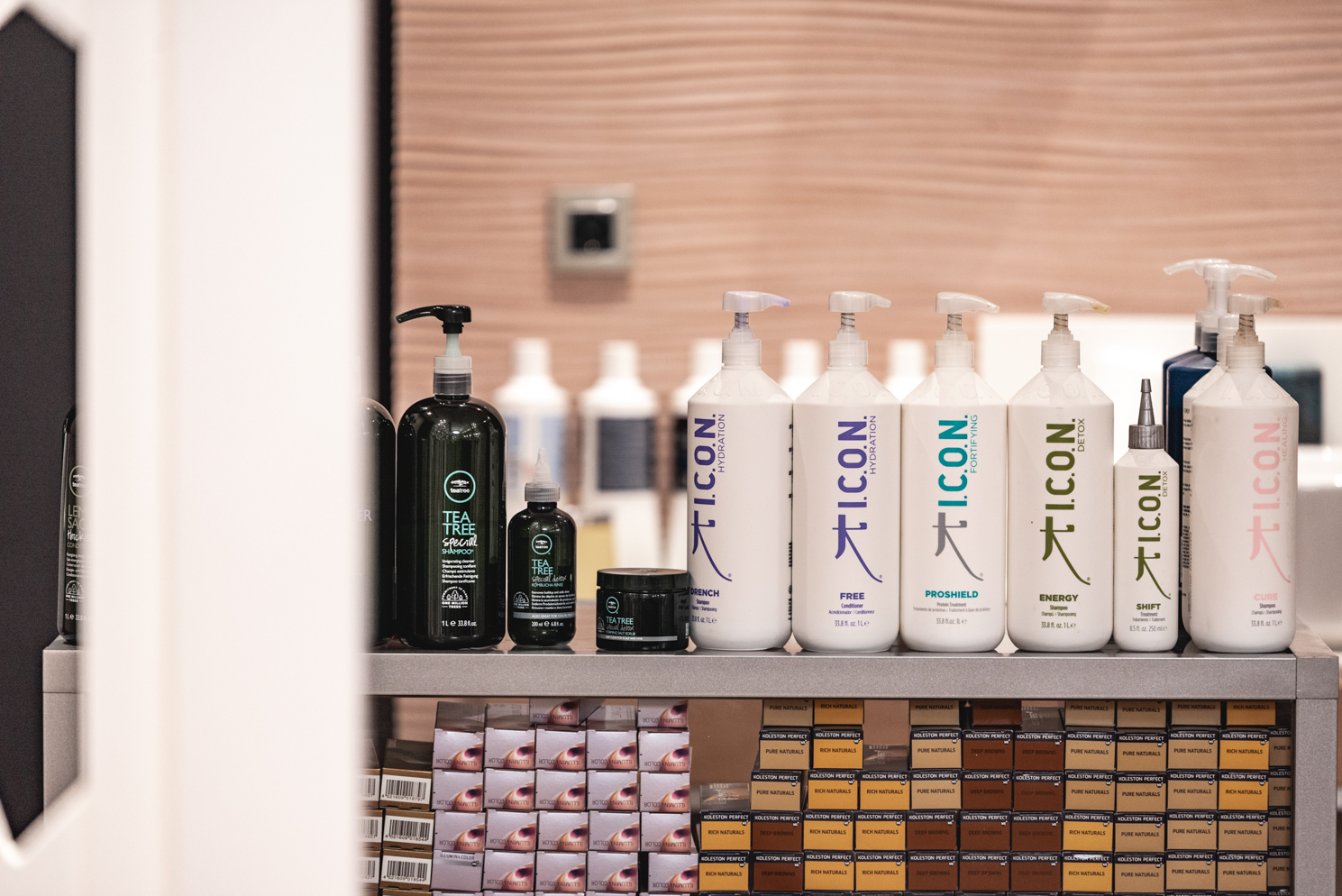 Professional I.C.O.N. and Tea Tree hair care products displayed in salon