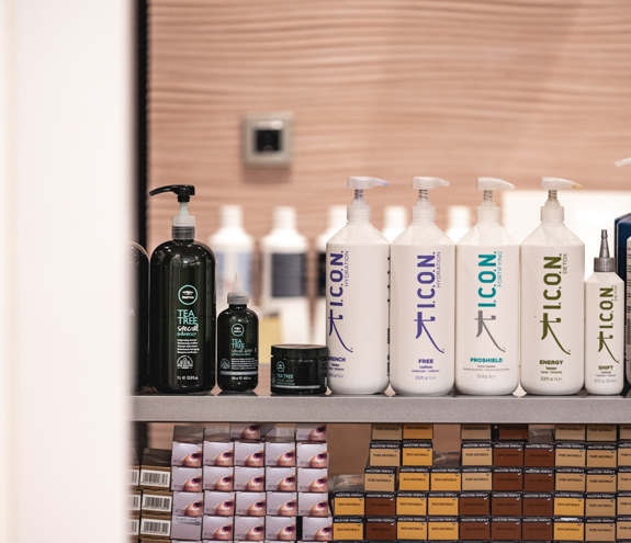 Professional I.C.O.N. and Tea Tree hair care products displayed in salon