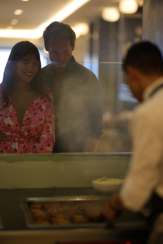 Couple waiting to be served by a chef in the live cooking area of Kritamo restaurant