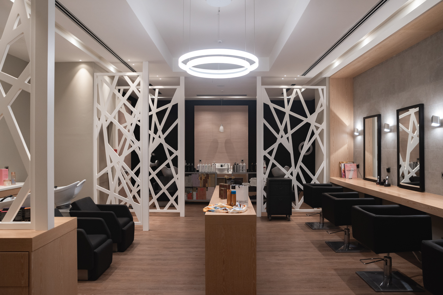 Modern hair salon with wash stations and design styling chairs at Lefas Hair Operatiors