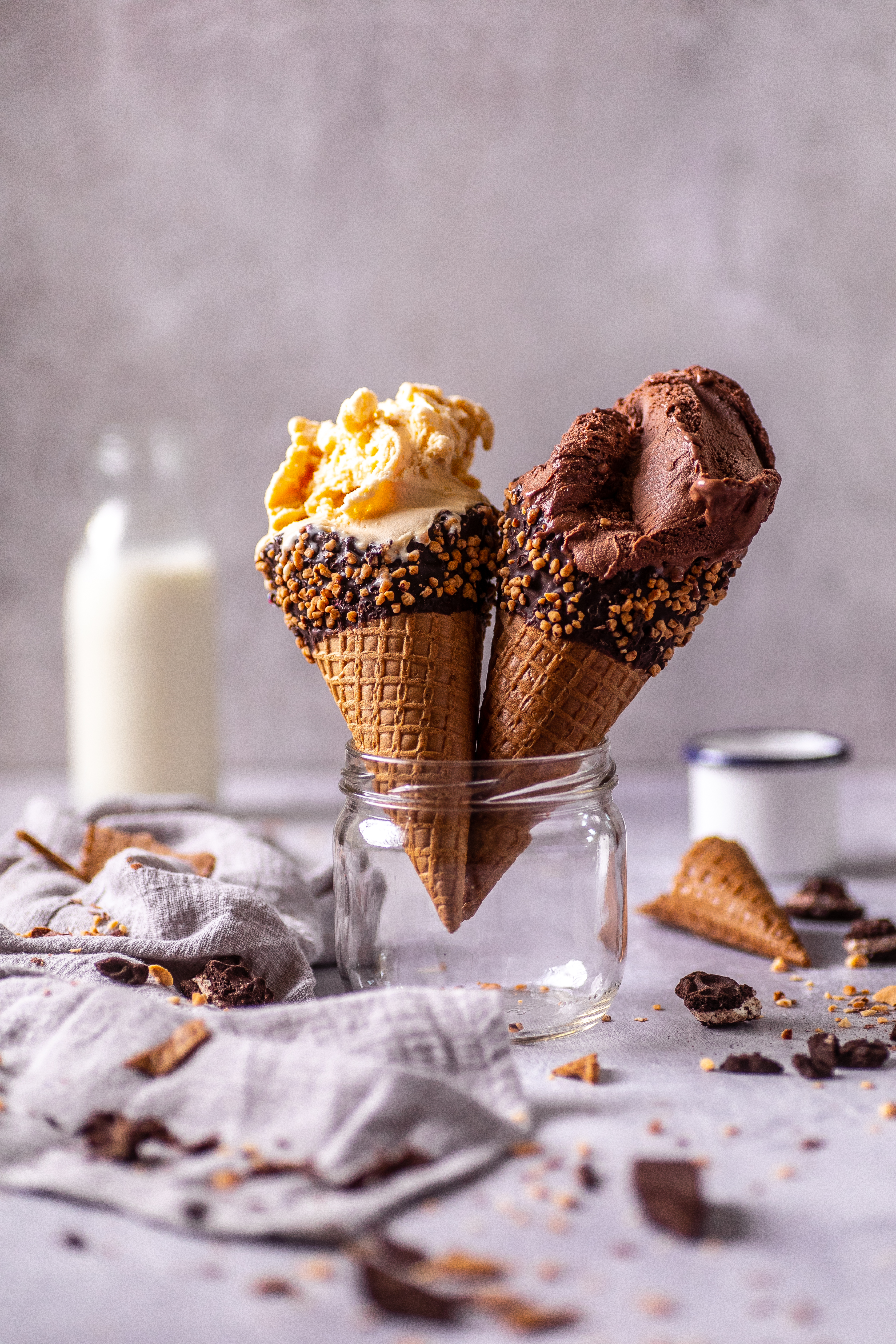 Fregio chocolate and caramel ice cream cones with crushed nuts in waffle cups
