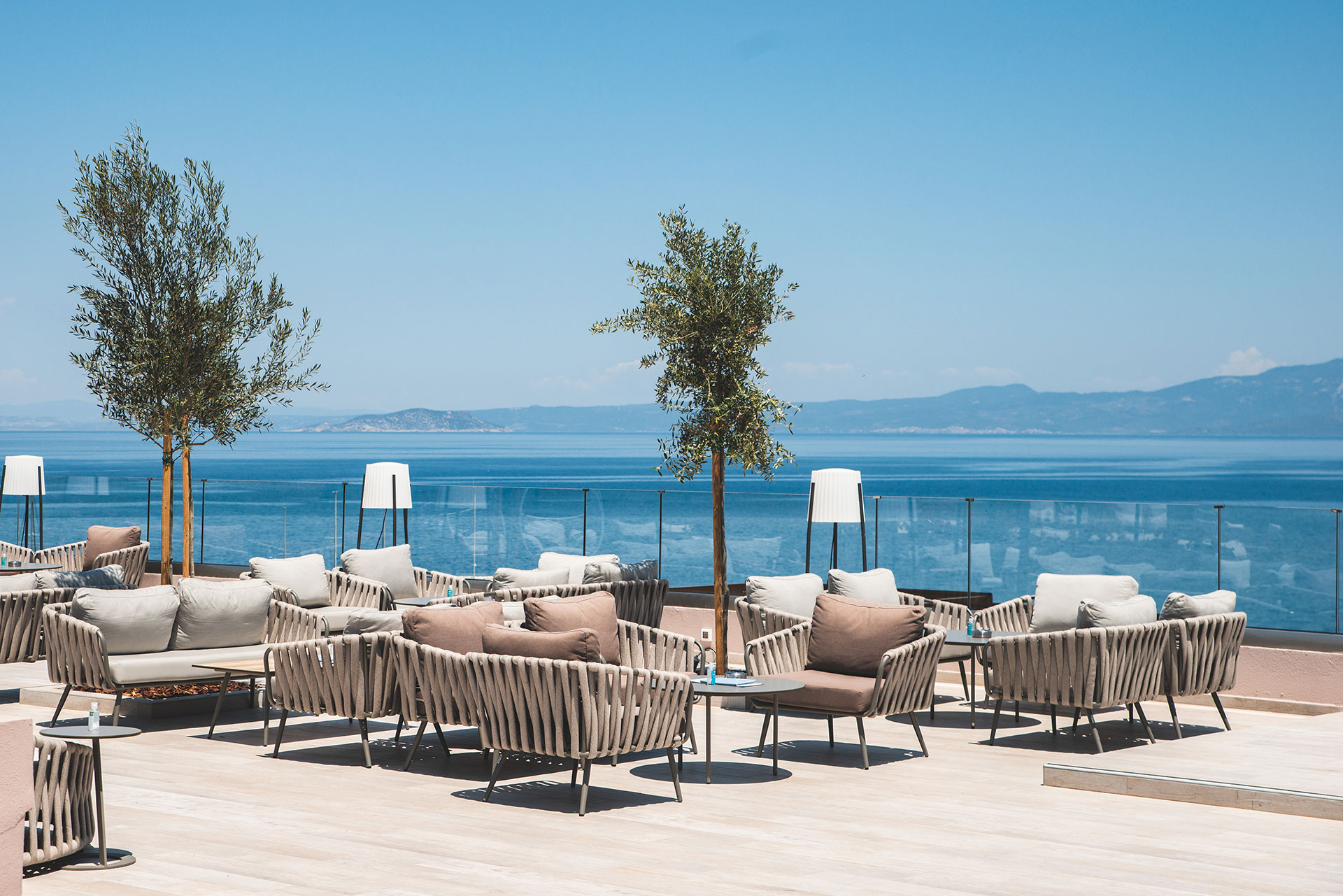 Modern outdoor lounge area with sea view and comfortable seating