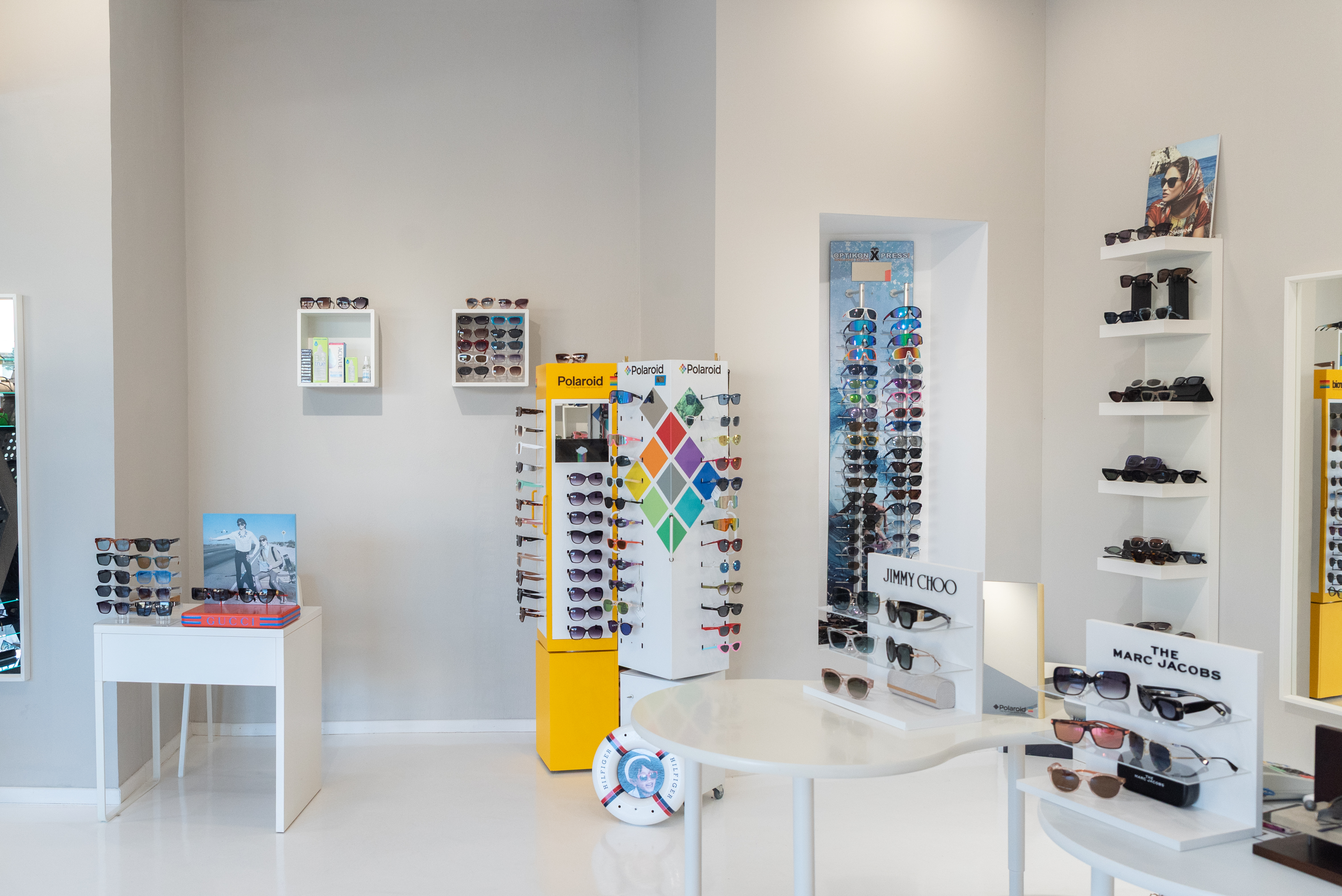 Modern interior of Optikon Xpress showcasing luxury sunglasses from brands like Jimmy Choo, Marc Jacobs, Polaroid
