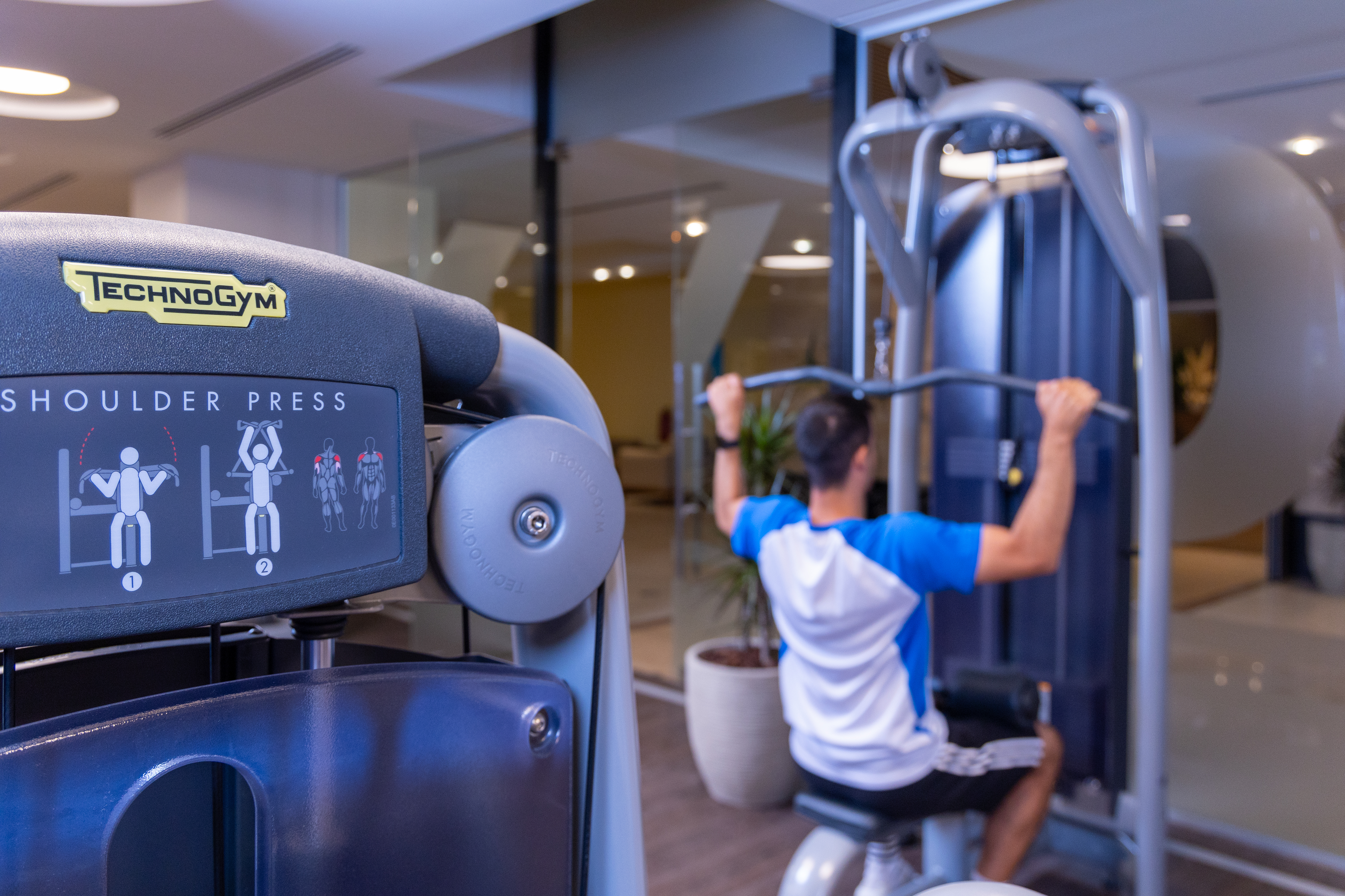 Close up of gym equipment with a person training in the background