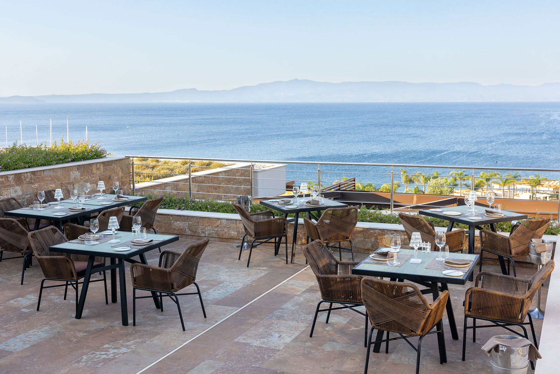 Sommelier's 8 restaurant terrace with elegant sea view dining setup overlooking the Aegean
