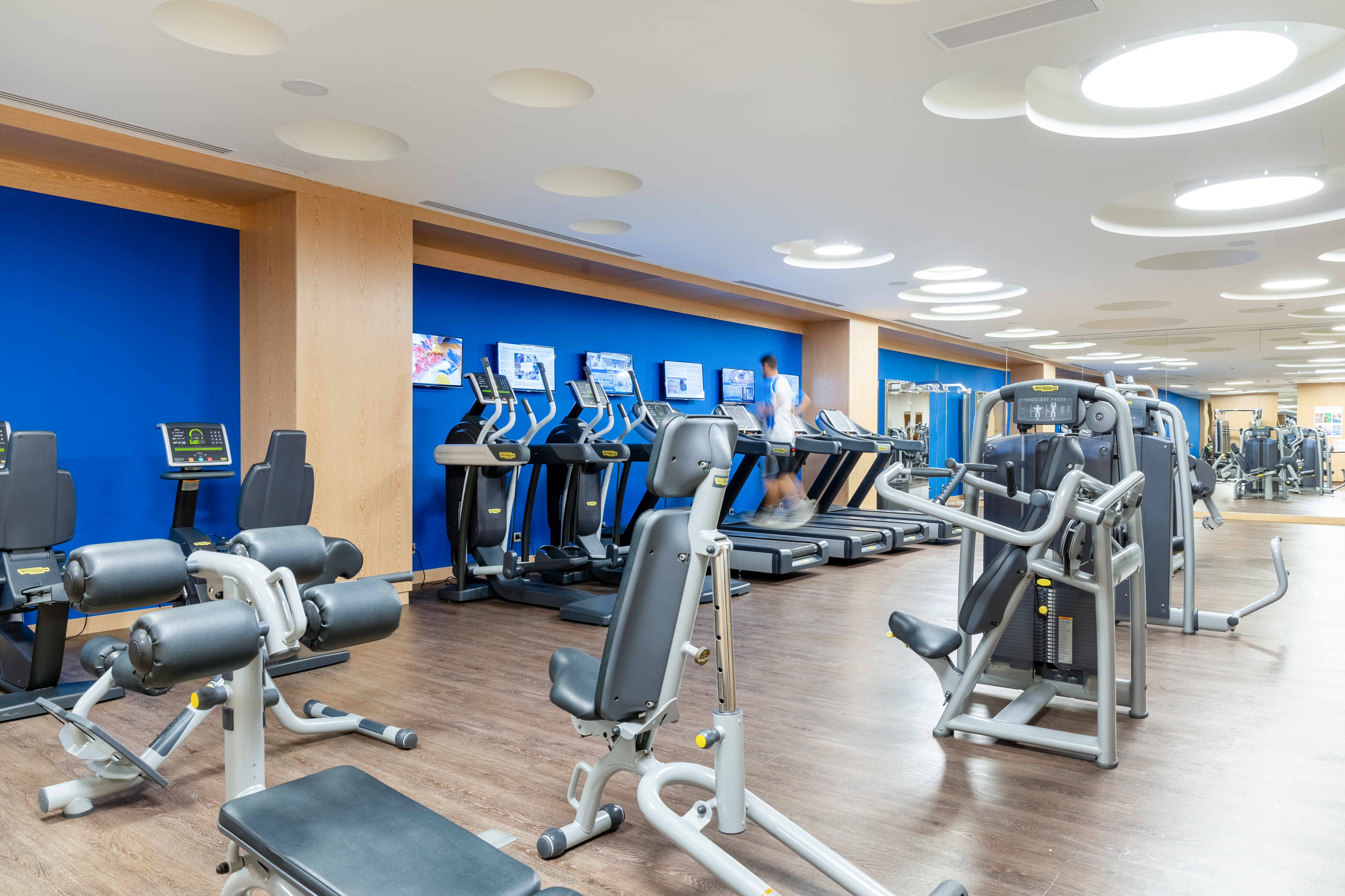 Fully equipped gym with cardio and strength machines in a bright modern space