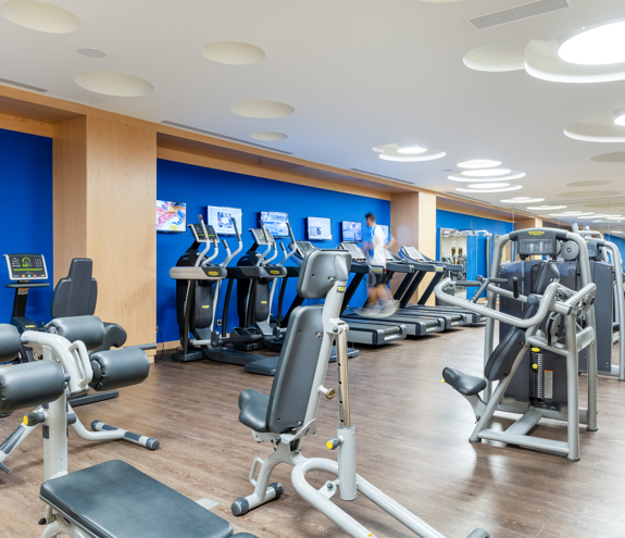 Fully equipped gym with cardio and strength machines in a bright modern space