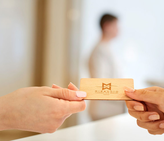 Guest receiving room key card during check-in at Mirragio Thermal Spa Resort