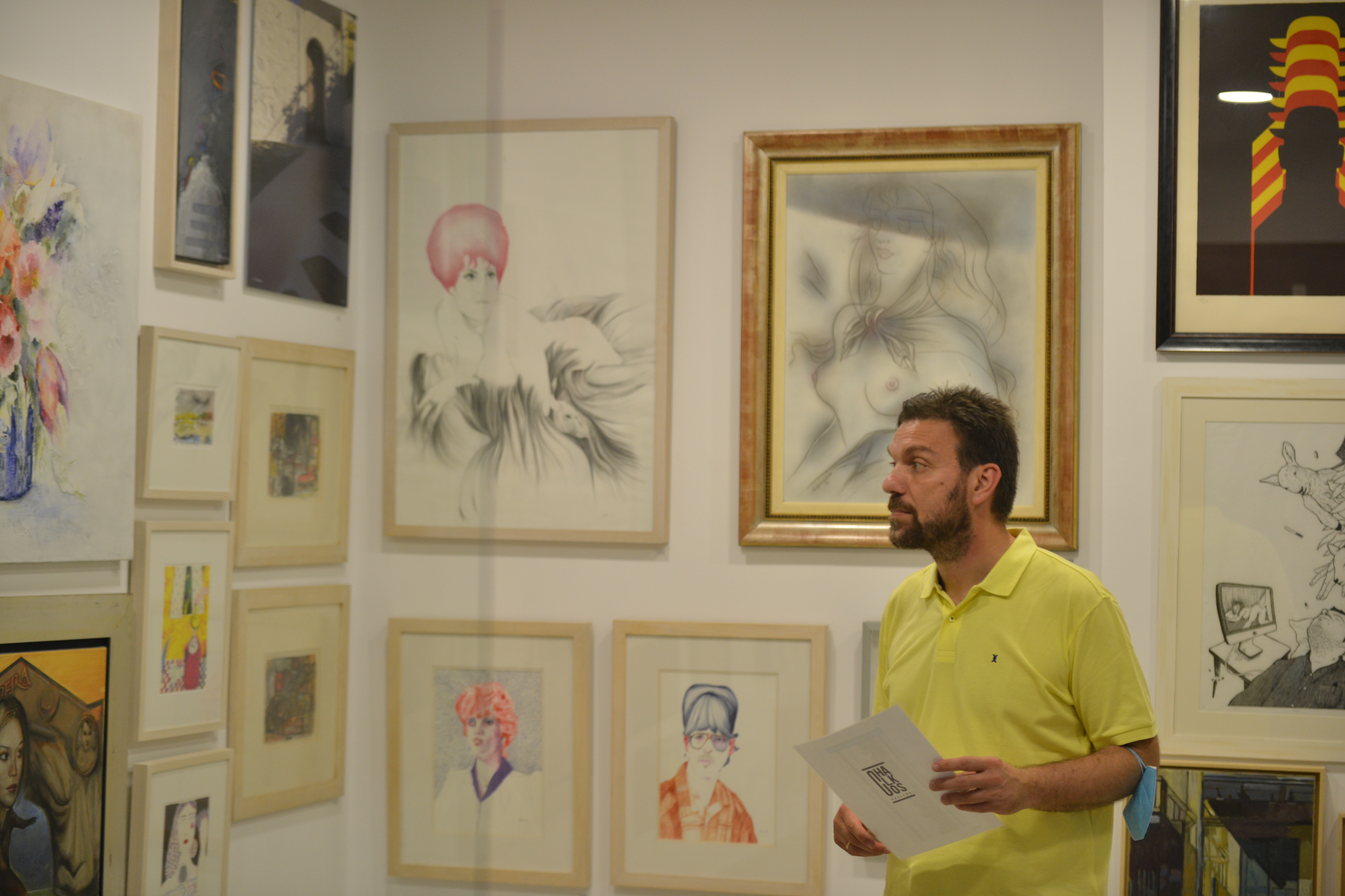 Guest admiring contemporary artworks and portraits inside the Miraggio resort art gallery