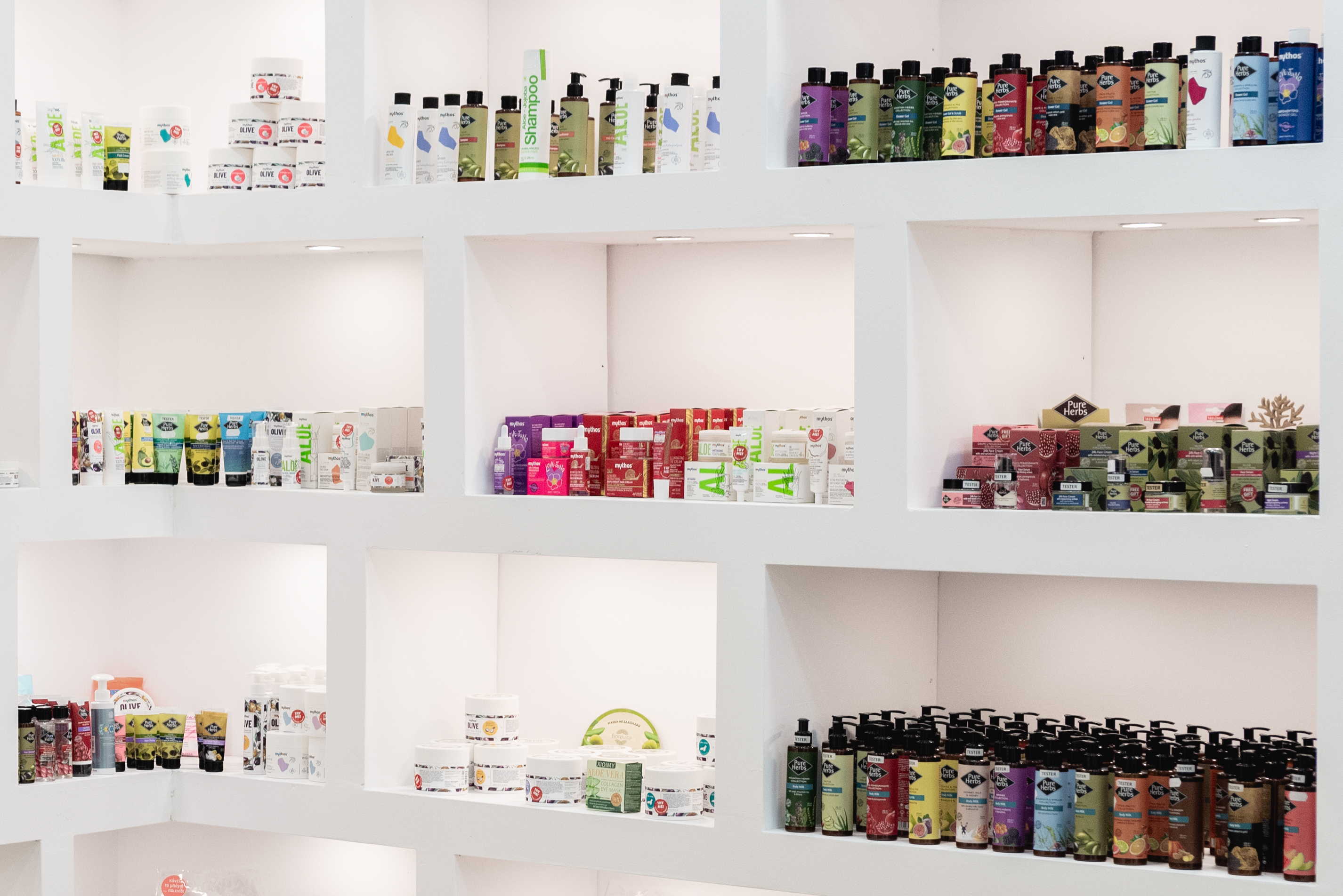 Pharmacy shelves stocked with shampoos, creams, and various beauty and personal care products