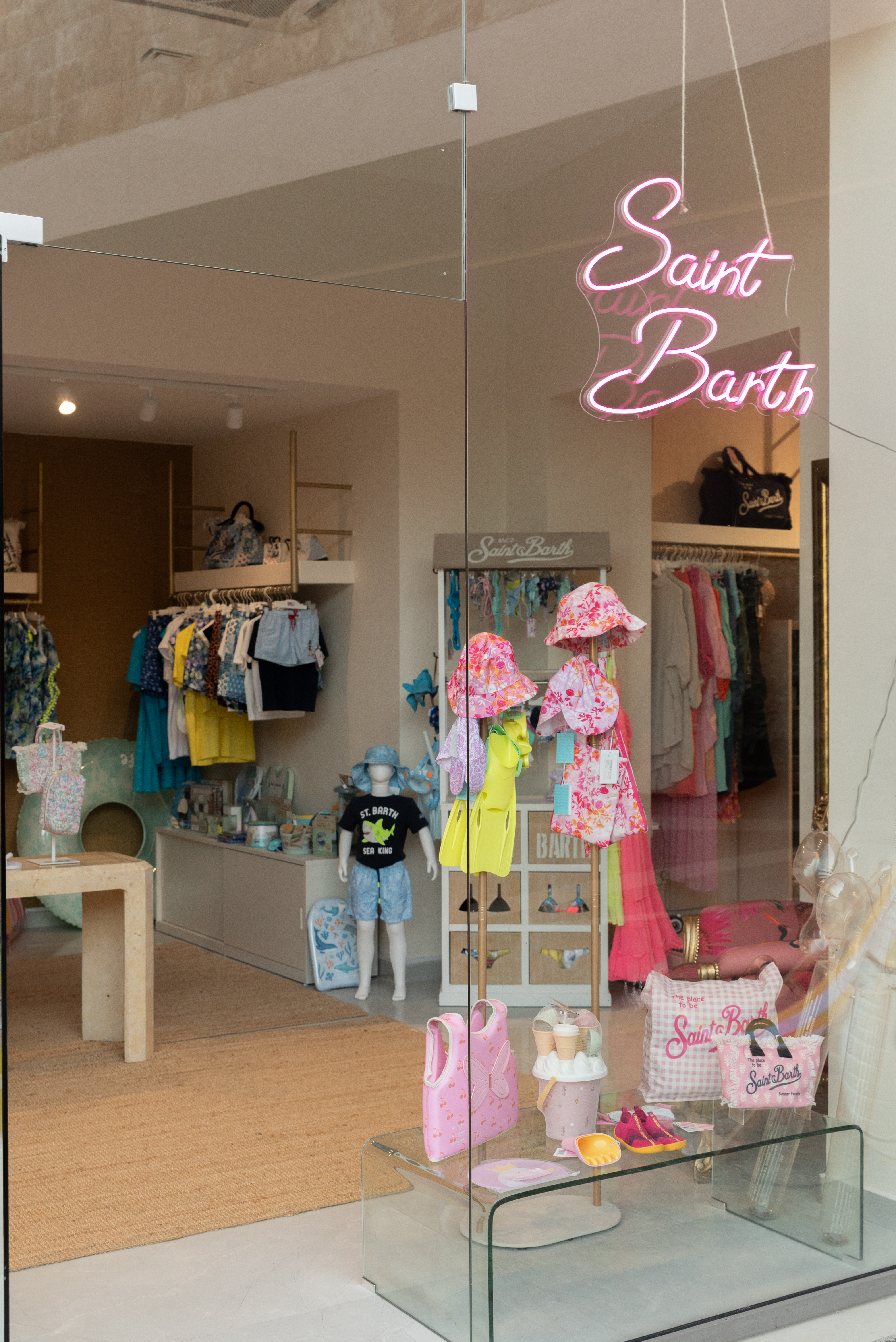 Storefront display with children's clothing, swimsuits, and accessories