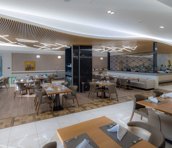 Spacious Kritamo restaurant interior with wooden designed roof, and tables