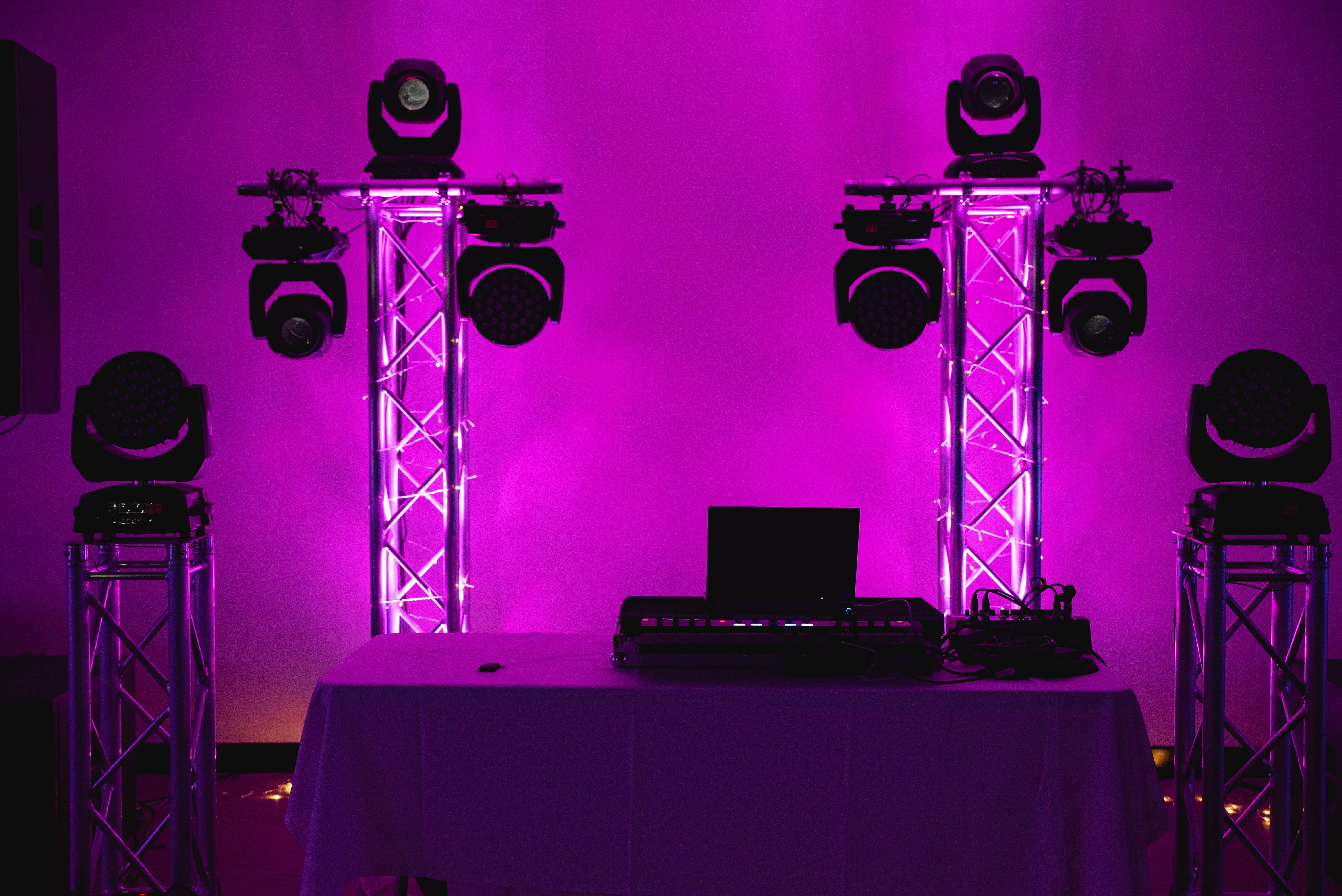 Wedding DJ setup illuminated by purple light