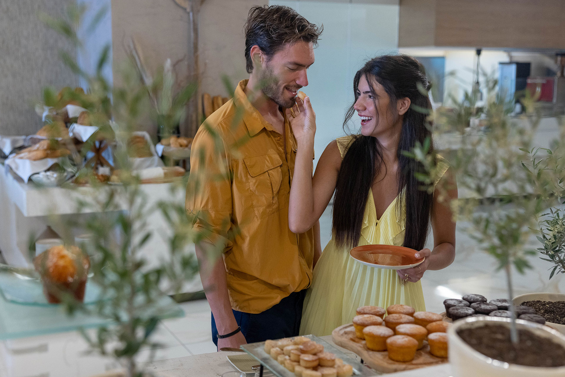 Couple enjoying freshly baked pastries at the breakfast buffet