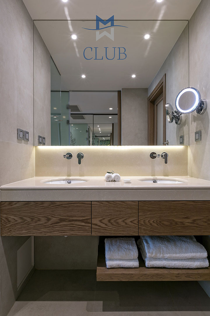 Elegant bathroom of club sea view room, with twin basins and vanity