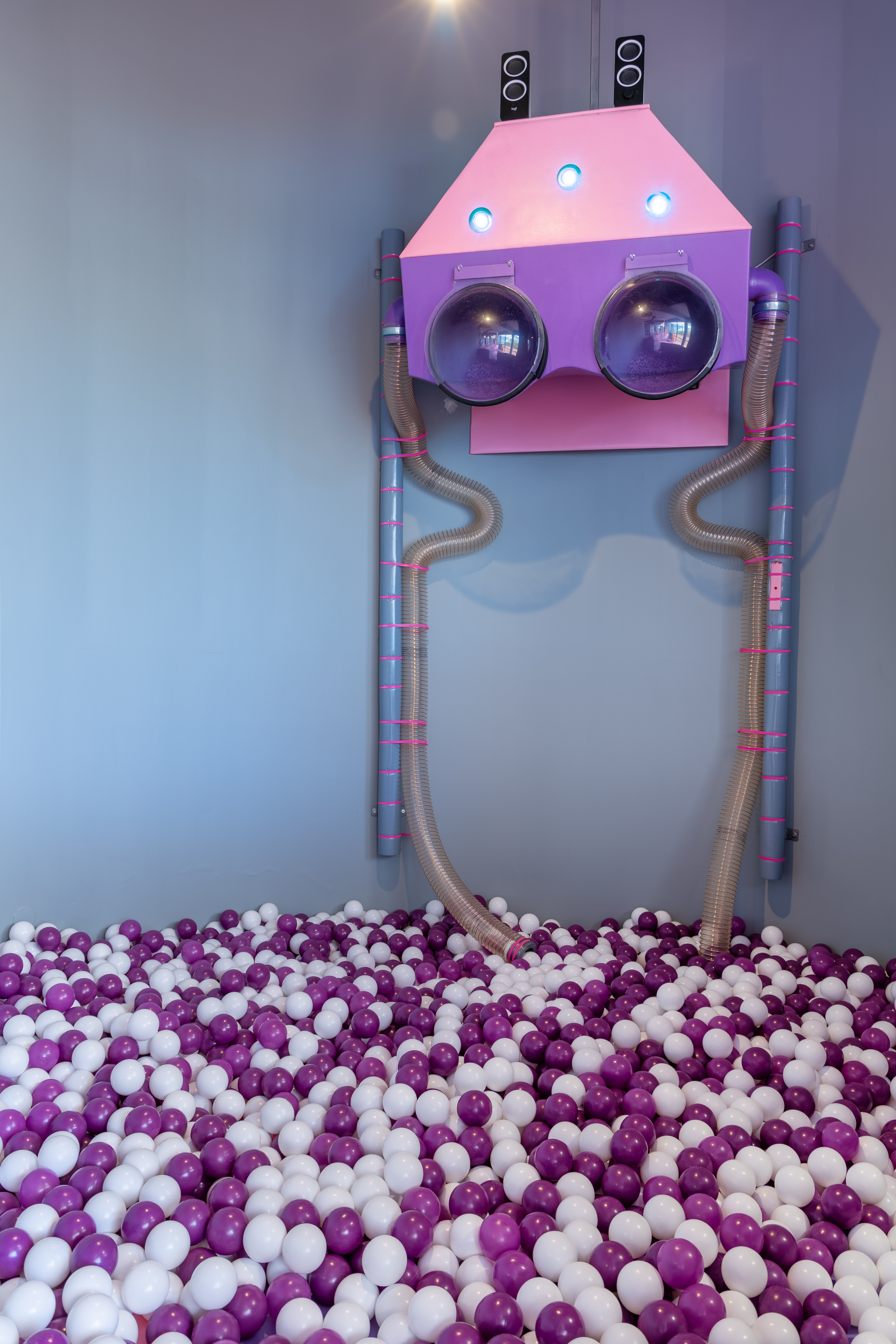 Interactive ball pit area with playful robot design and colorful balls at Kids Planet