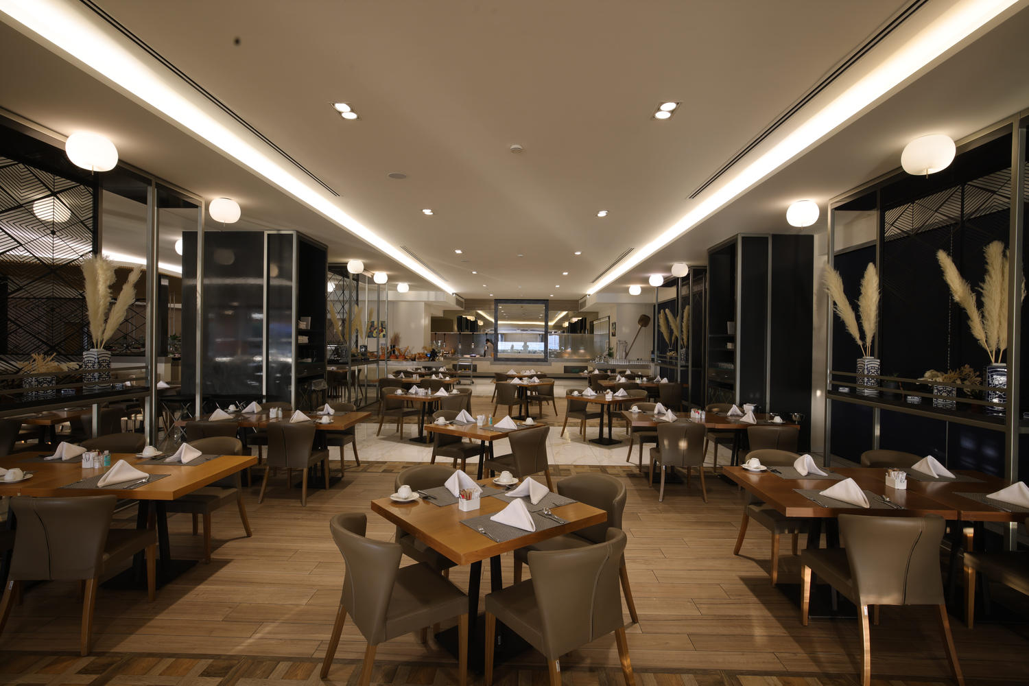 Kritamo restaurant elegant interior with warm lighting, and wooden floor and furniture