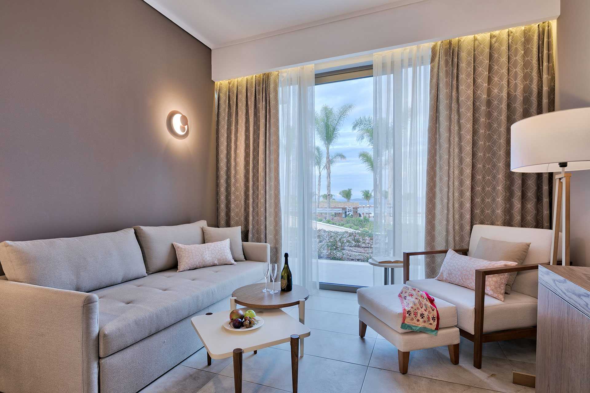 Deluxe room's seating area with cozy furniture and ambient warm lighting