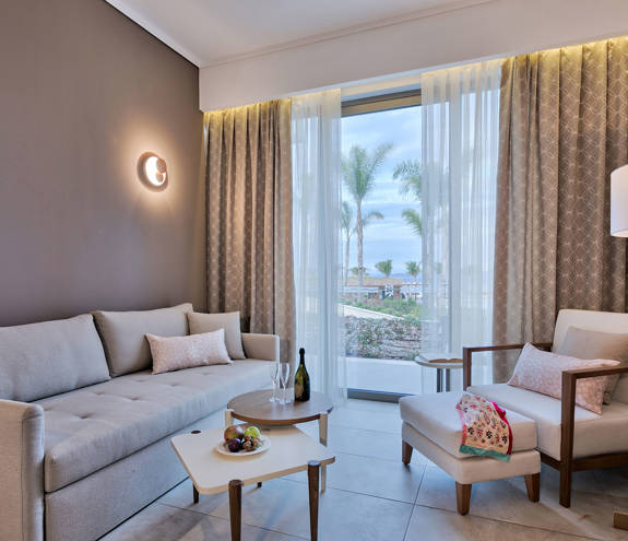 Deluxe Pool Front Room sofa, armchair and decorated table